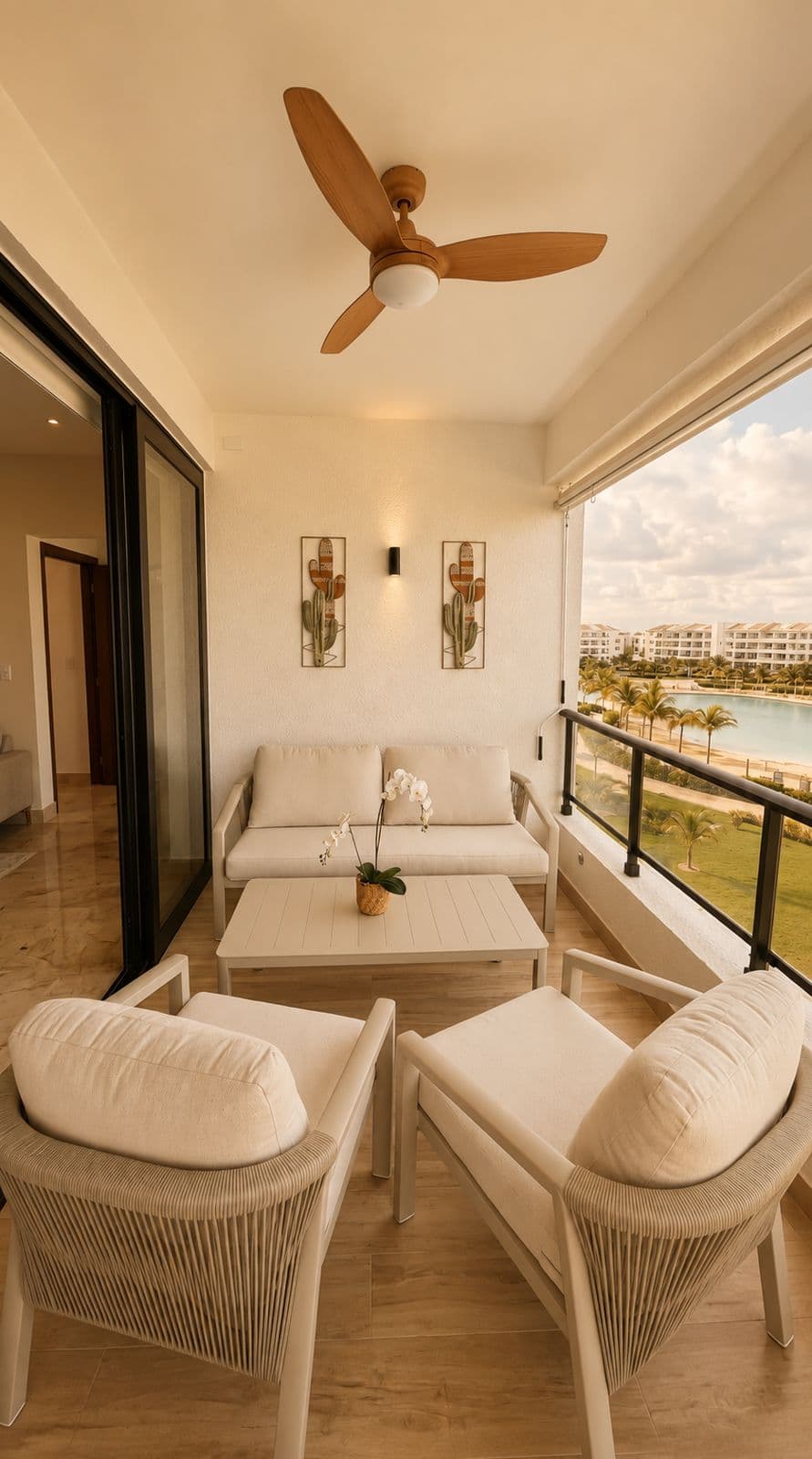 Balcony with white outdoor furniture overlooking a lagoon