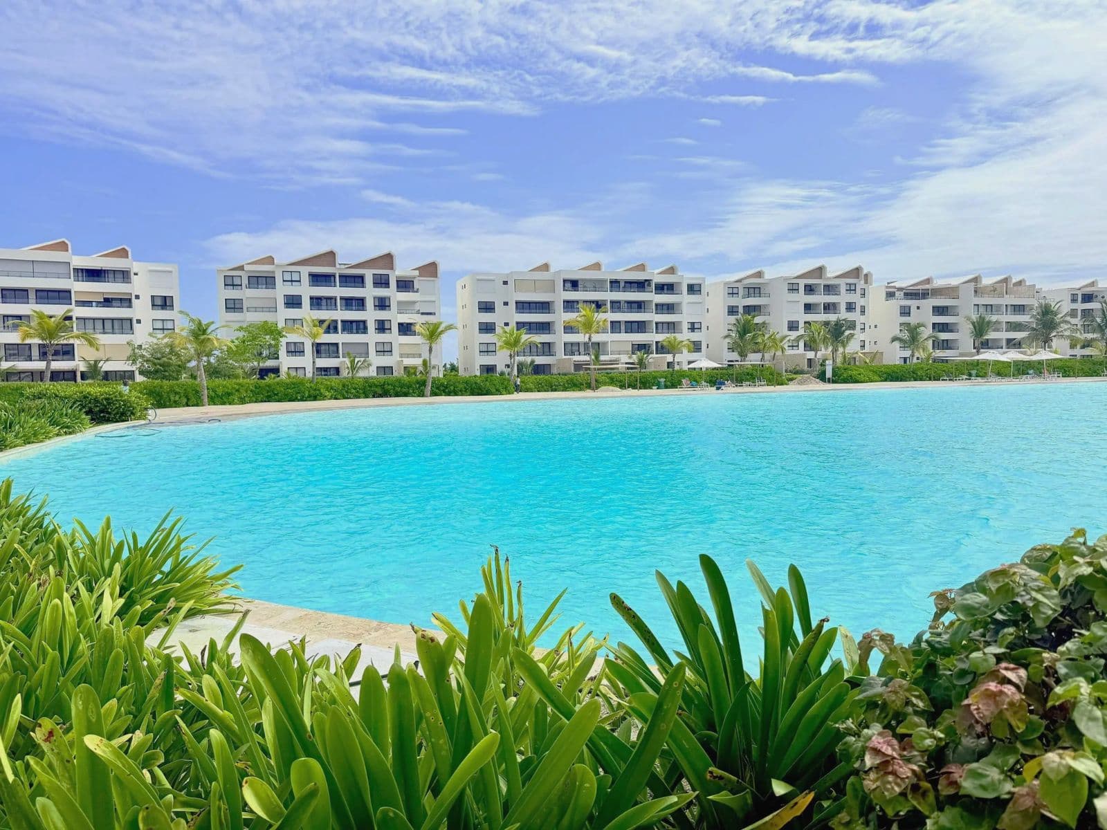 Turquoise lagoon pool in front of a residential complex