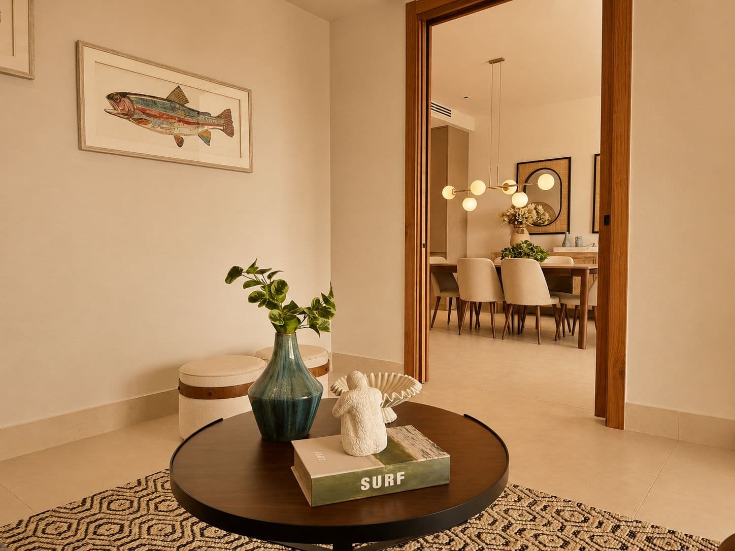 Entry hall with a round table, a blue vase and a book on surfing