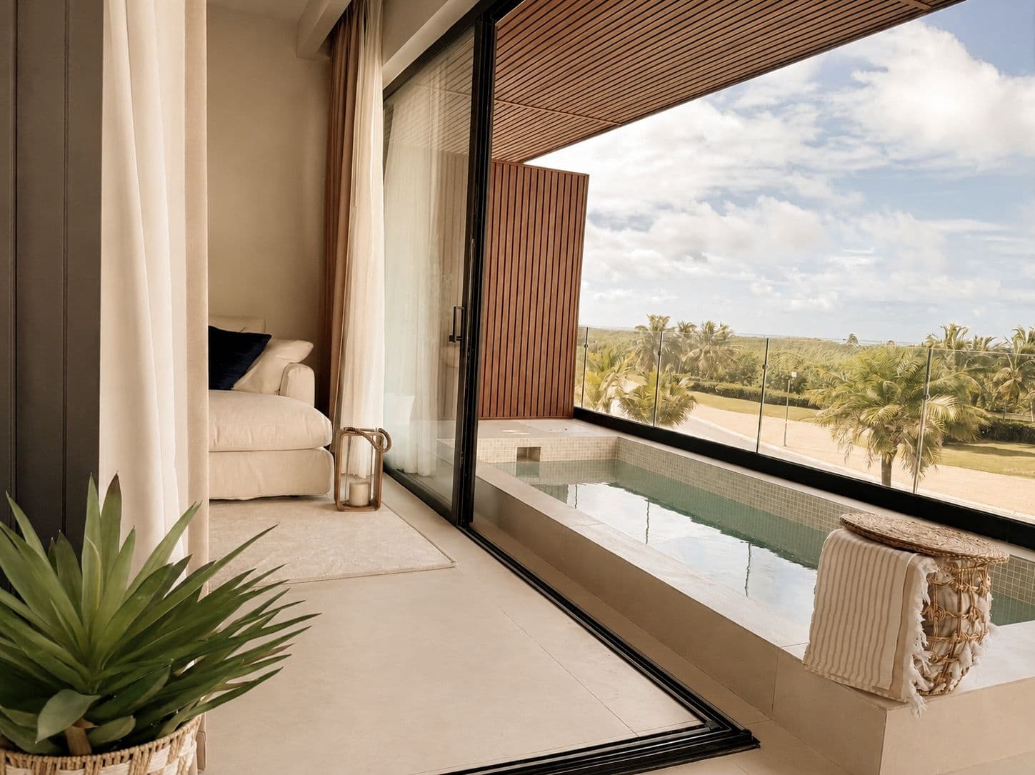 Bedroom opening onto a private plunge pool and a tropical view